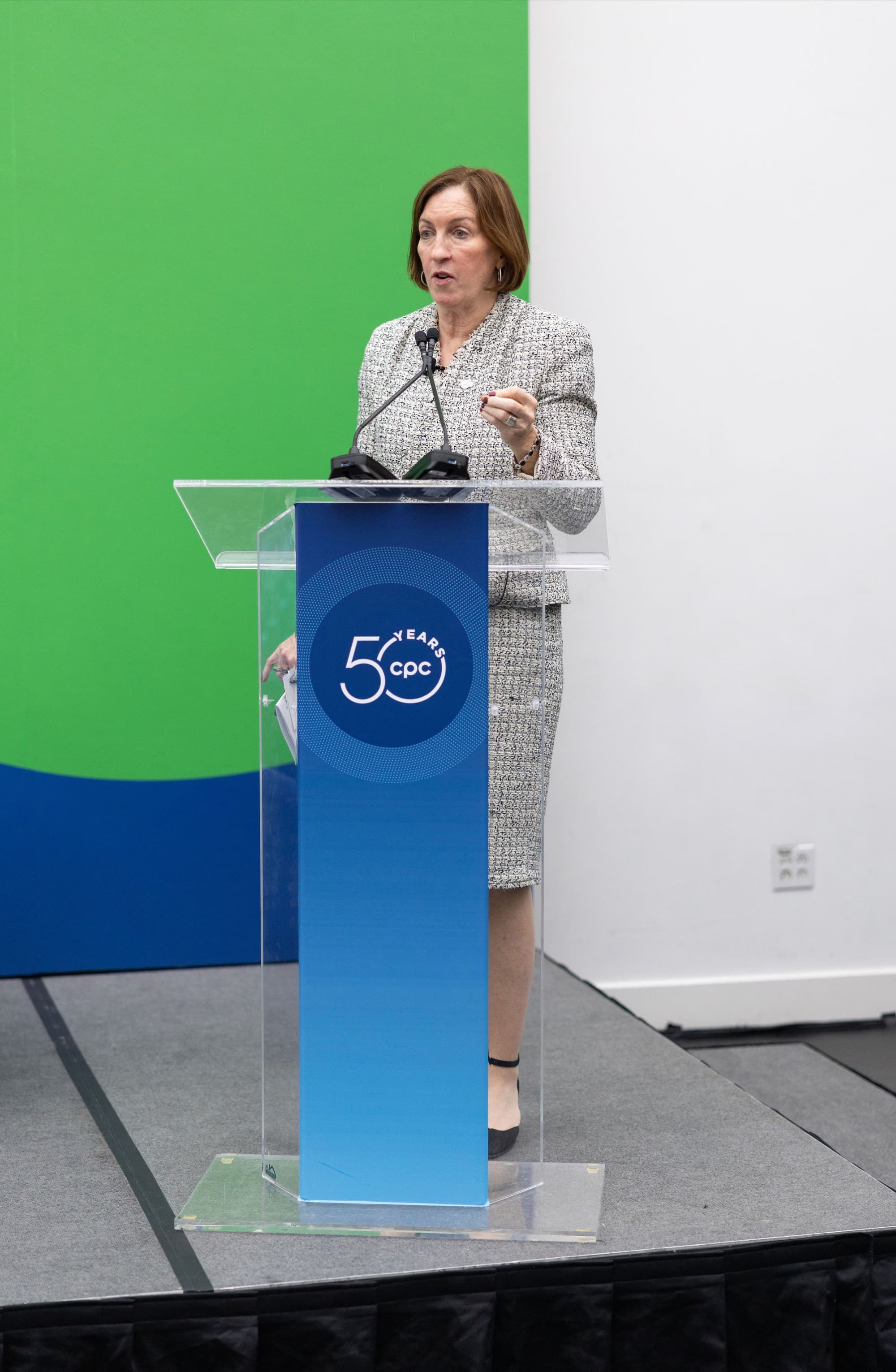 Sadie at podium which reads '50 years cpc'.
